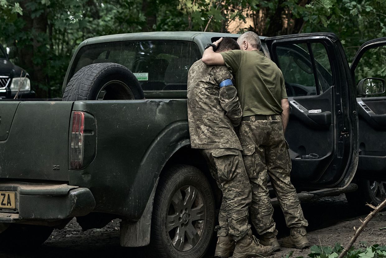 A Ukrainian soldier cries on his comrade's shoulder after returning from the Kursk region, on Aug. 14, 2024. 