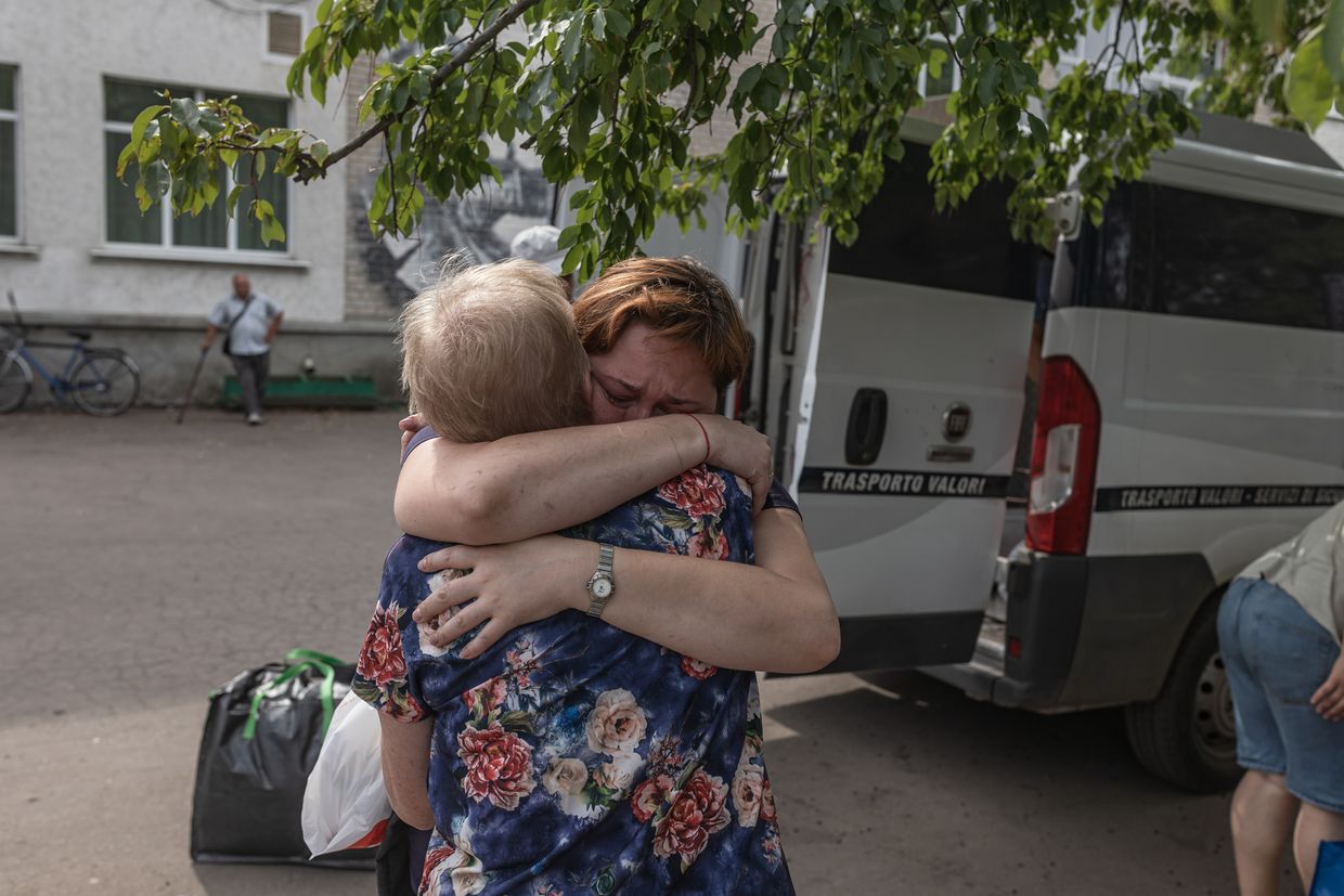 A woman hugs a friend after being evacuated from Selydove due to the advance of Russian troops in Pokrovsk, Ukraine, on Aug. 27, 2024.