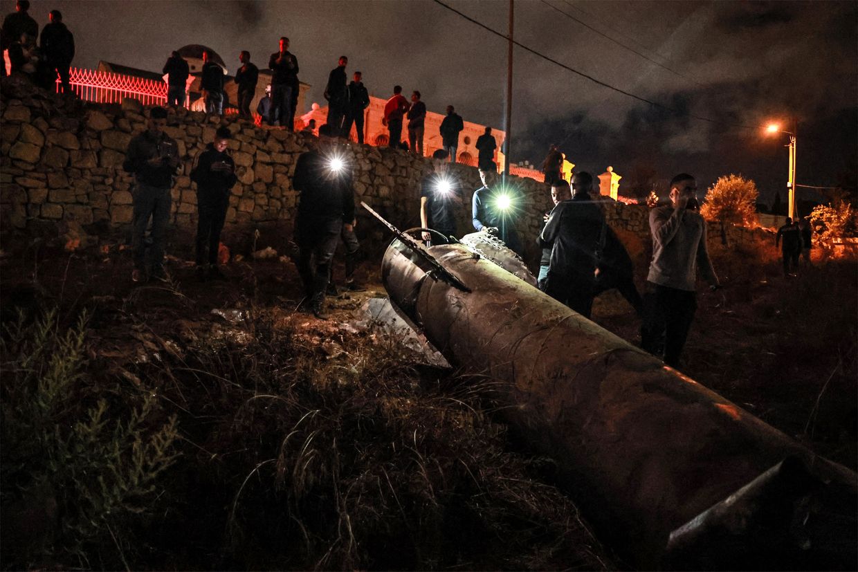 Palestinian youths inspect a fallen projectile after Iran launched a barrage of missiles at Israel in Ramallah in the occupied West Bank on Oct. 1, 2024.