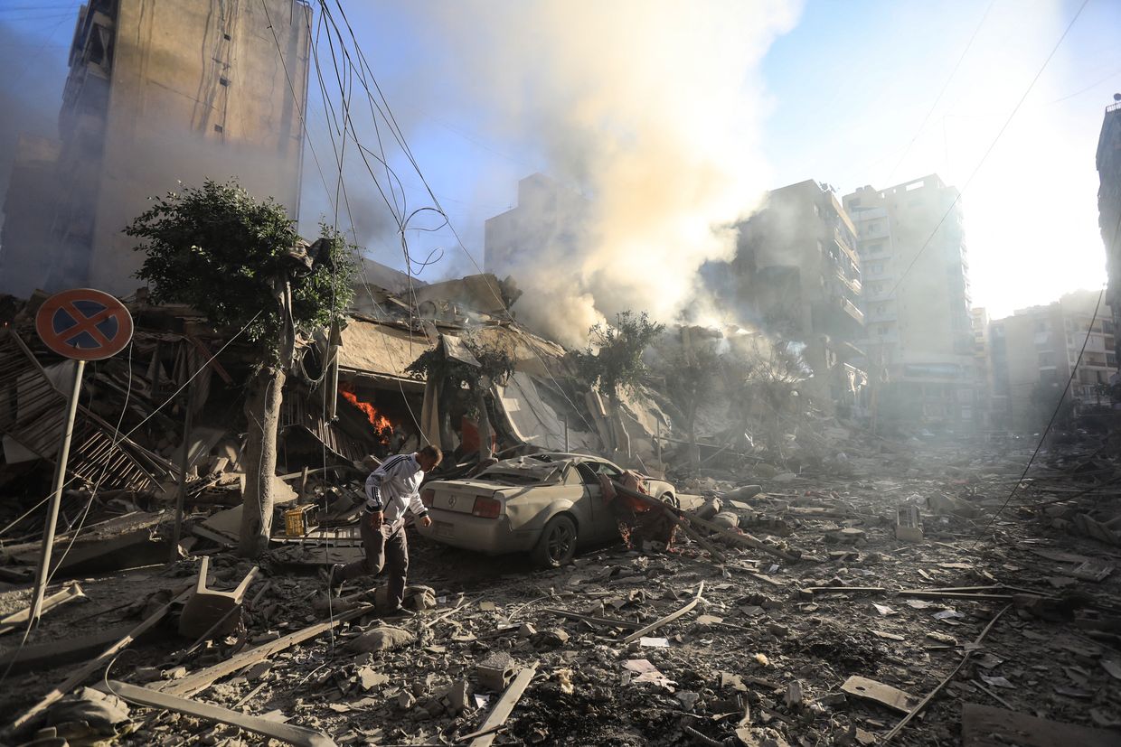 A man walks amid the rubble of a building hit in an overnight Israeli airstrike of Lebanon