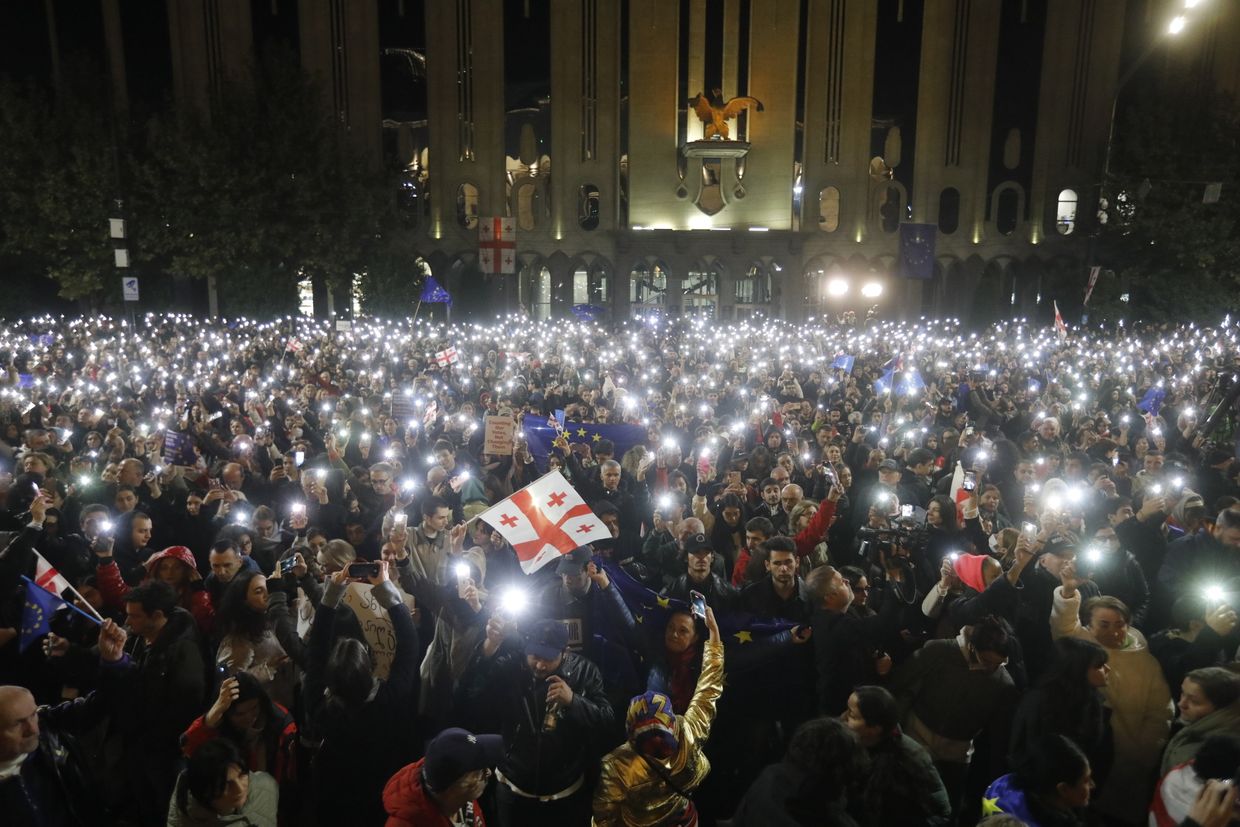 People attend an opposition rally where President Salome Zurabishvili protests the parliamentary election results outside the Tbilisi parliament on Oct. 28, 2024.