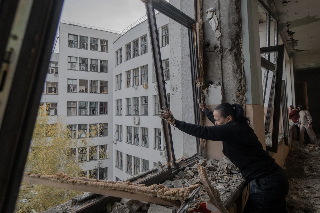 A woman cleans debris inside the damaged Derzhprom building, a historic Soviet skyscraper, after a missile attack in Kharkiv on Oct. 29, 2024.