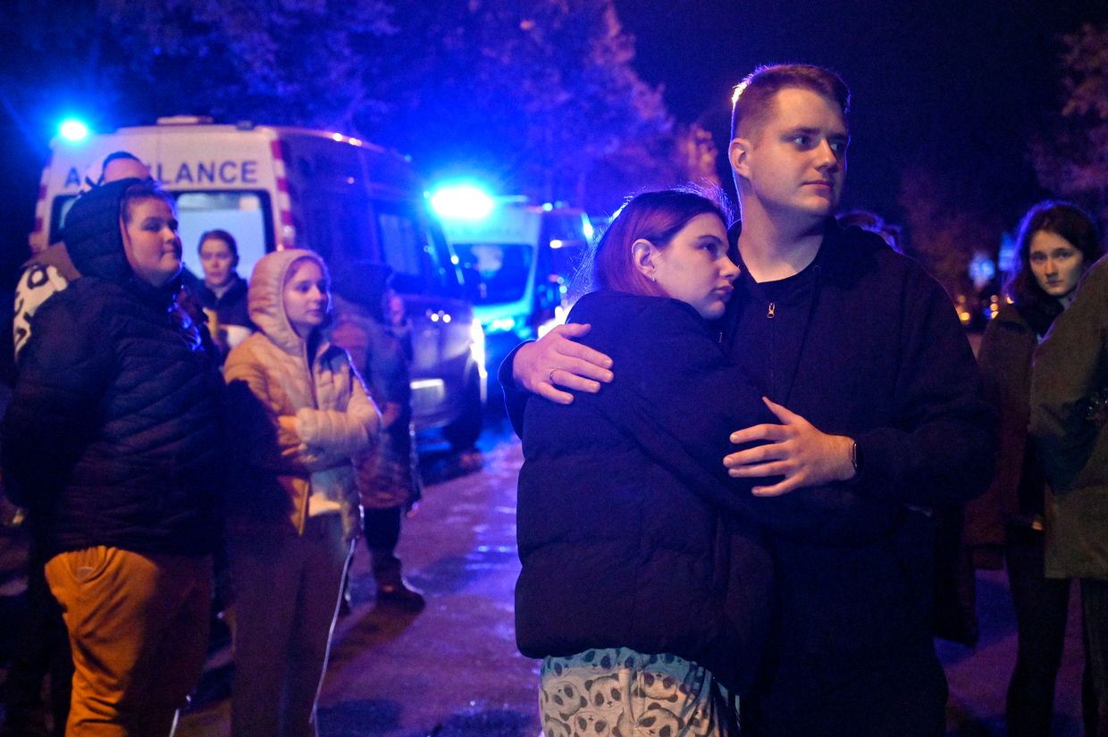 Residents stay outside an apartment block in the Solomianskyi district hit by a Russian drone attack in Kyiv, Ukraine on Oct. 25, 2024.