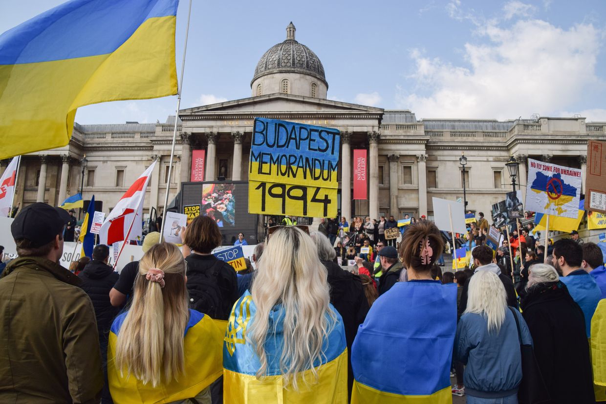  A protester holds a "Budapest Memorandum 1994" placard in Ukrainian colors during a demonstration in Trafalgar Square, London, UK, on March 3, 2022.