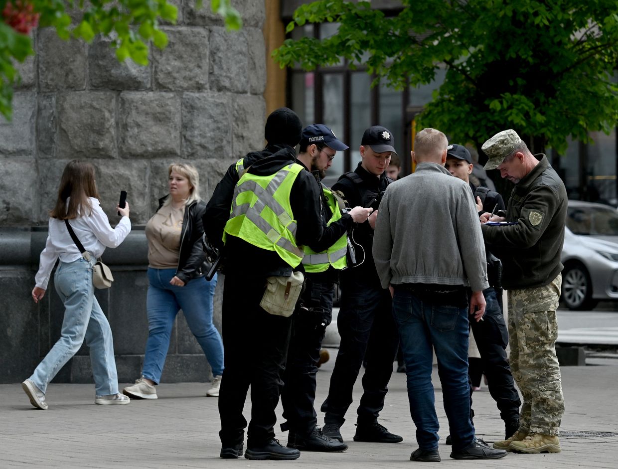 Ukrainian serviceman and police officers check the documents of a man in the center of Kyiv, Ukraine on April 25, 2024. 