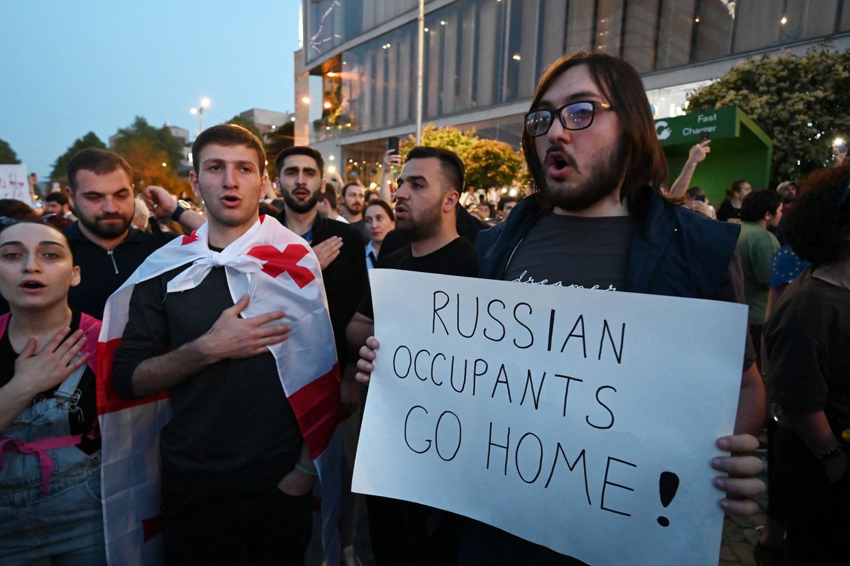 A man holds an anti-Russia placard at a protest against a 'foreign influence' bill, warned by Brussels as undermining Georgia's EU aims, in Tbilisi, Georgia, on April 28, 2024.