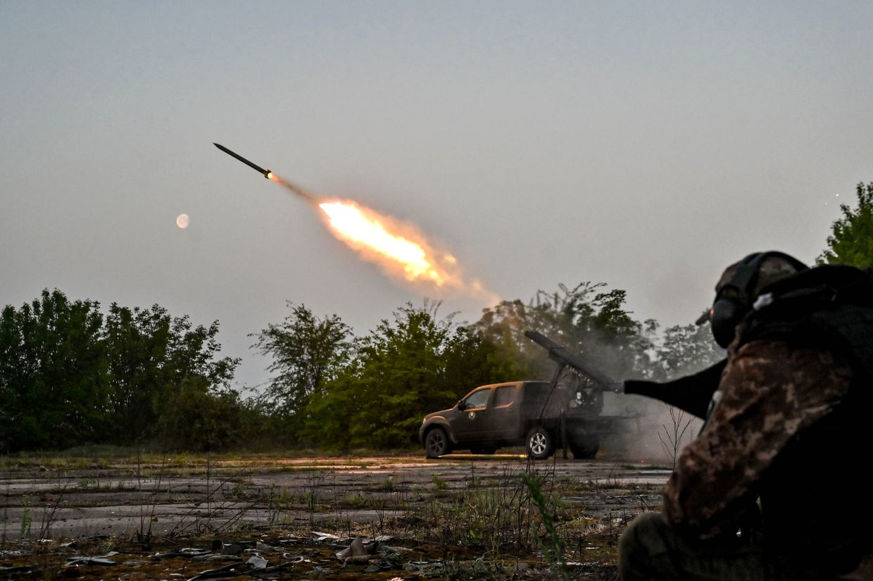 A serviceman is standing near a pickup equipped during a combat mission in the Zaporizhzhia Oblast, Ukraine