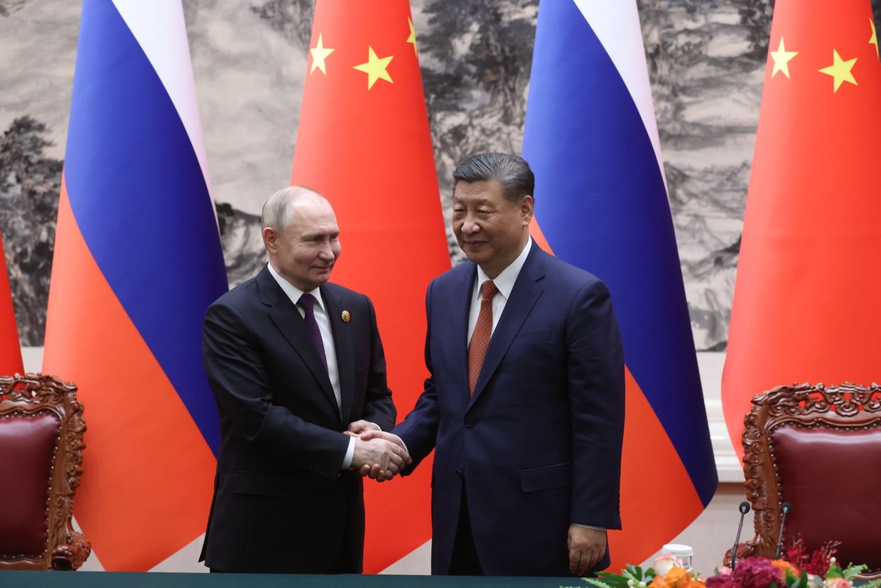 Russian President Vladimir Putin and Chinese President Xi Jinping shake hands during a meeting in Beijing, on May 16, 2024