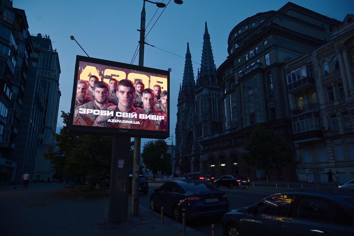  A recruiting placard for Ukraine's Azov Brigade during a partial blackout in central Kyiv, Ukraine, on June 22, 2024, amid Russia's invasion.