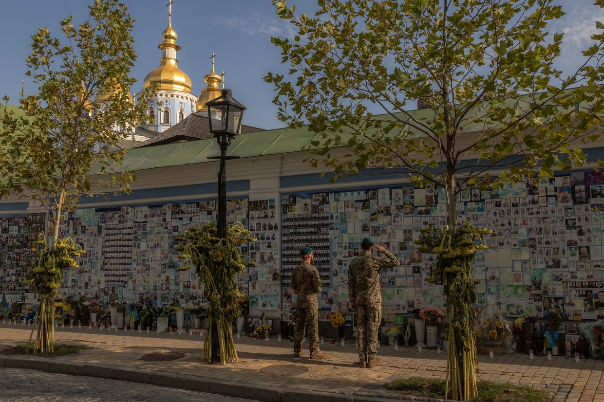 A Ukrainian serviceman salutes to commemorate fallen Ukrainian military members at the "Wall of Remembrance of the Fallen for Ukraine" in Kyiv, Ukraine on Aug. 29, 2024