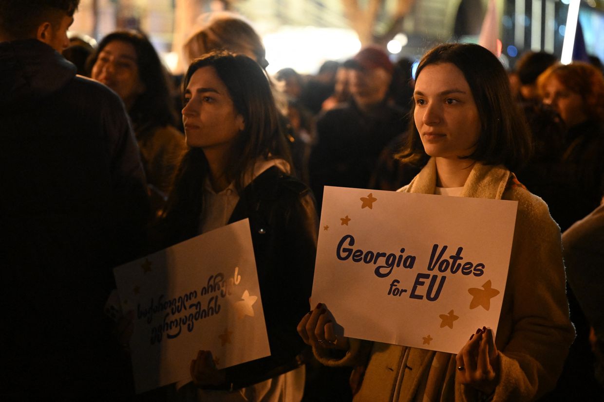 A protester holds a placard at a pro-Europe rally ahead of Georgia's parliamentary elections in Tbilisi, on Oct. 20, 2024.