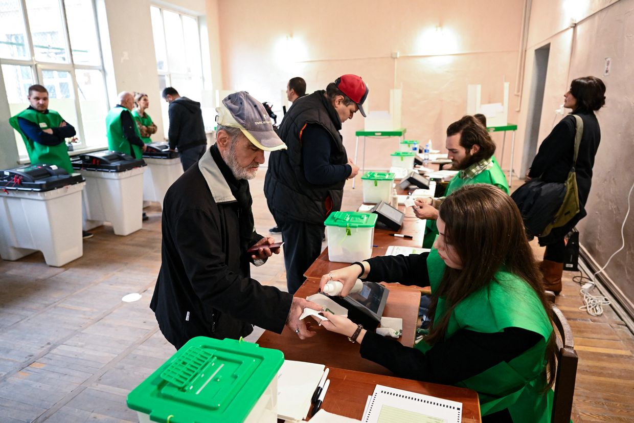 Georgians vote in the country's parliamentary elections at a polling station in Tbilisi, Georgia on Oct. 26, 2024. 