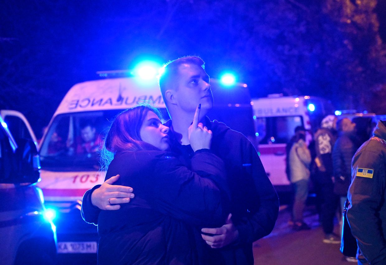 Residents stand outside an apartment block in the Solomianskyi district of Kyiv hit by a Russian drone attack, on Oct. 25, 2024.