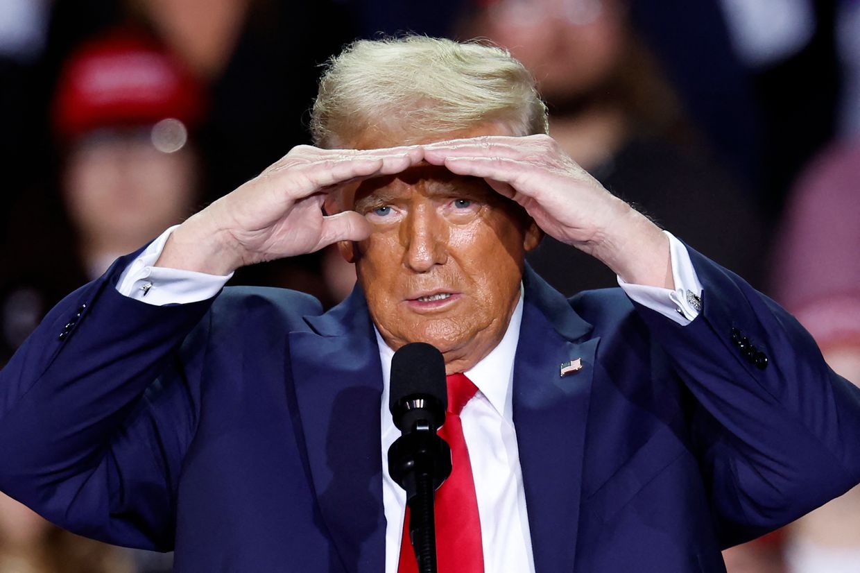 Former US President Donald Trump gestures as he speaks during a campaign rally in Grand Rapids on Nov. 5, 2024.