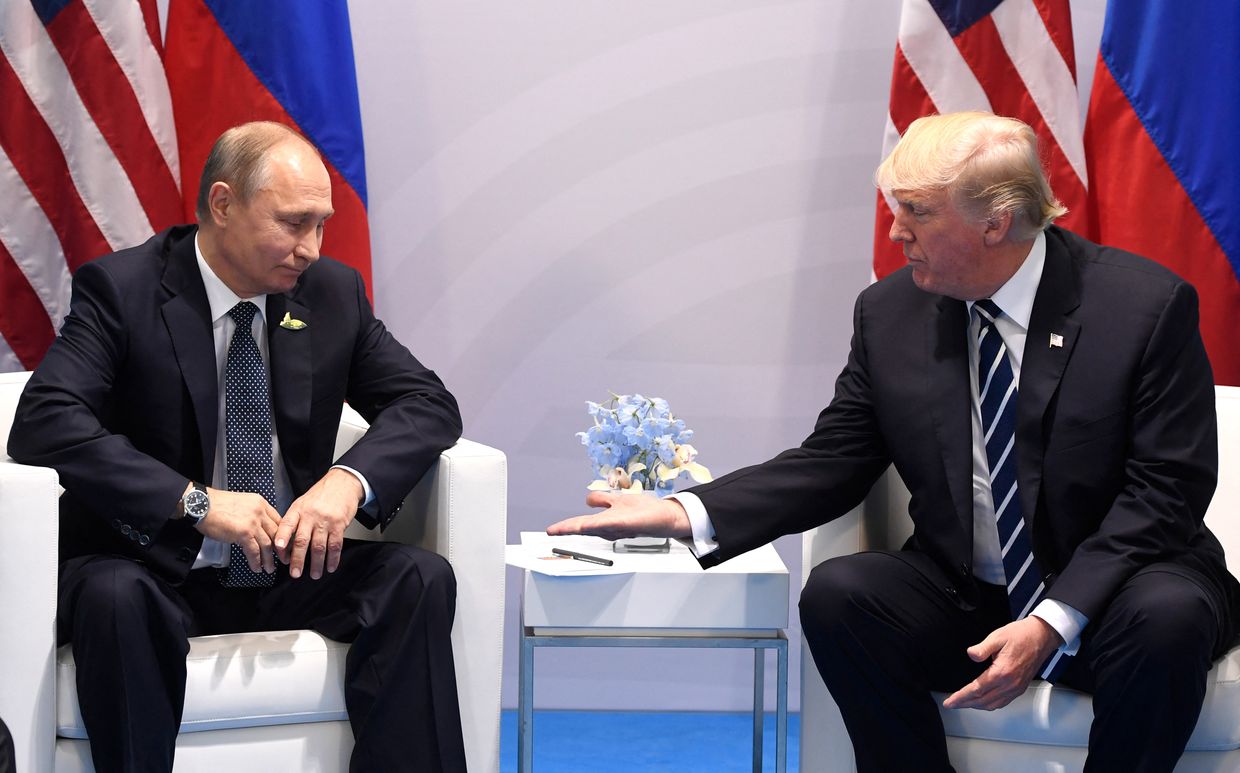 Donald Trump and Vladimir Putin shake hands during a meeting at the G20 Summit in Hamburg, Germany, on July 7, 2017.