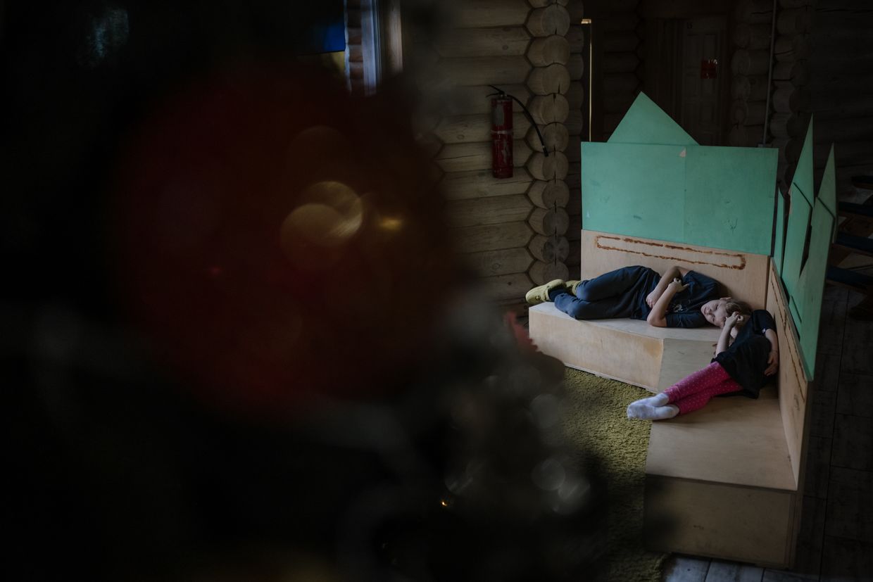 Children rest on the sofa in the hall at the "7 Fields" school near Kyiv, Ukraine on Dec. 5, 2024.