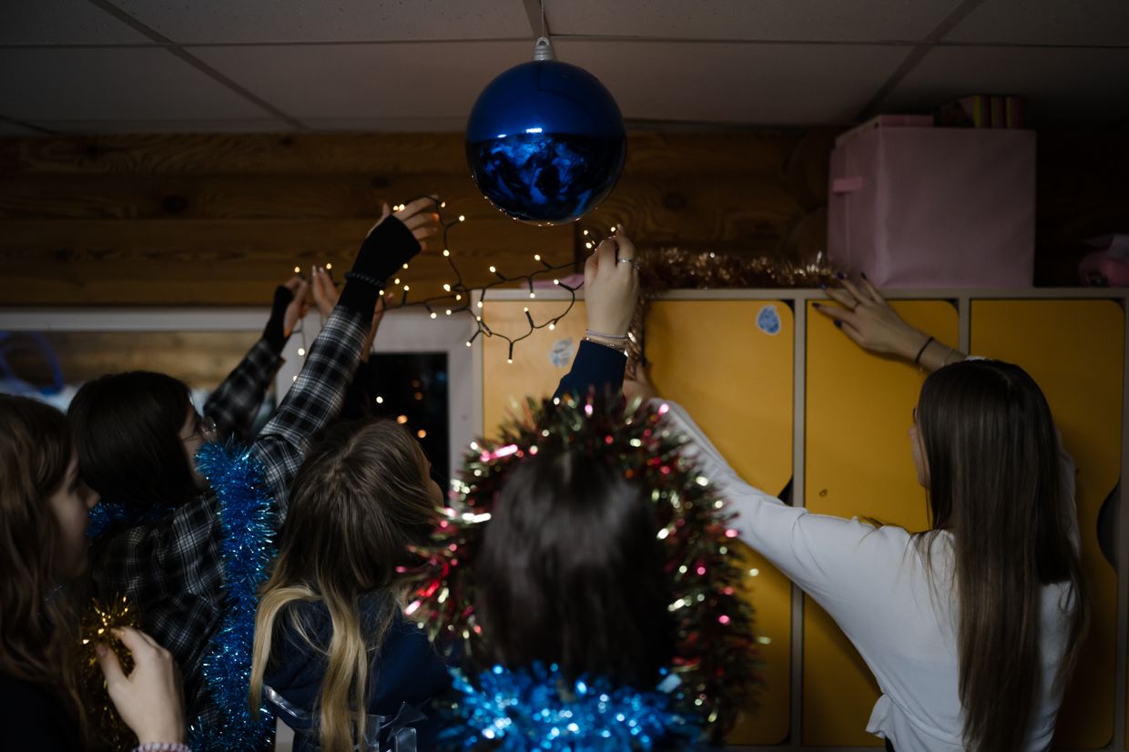 Children decorate their room with Christmas decorations at the "7Fields" school near Kyiv, Ukraine on Dec. 5, 2024.