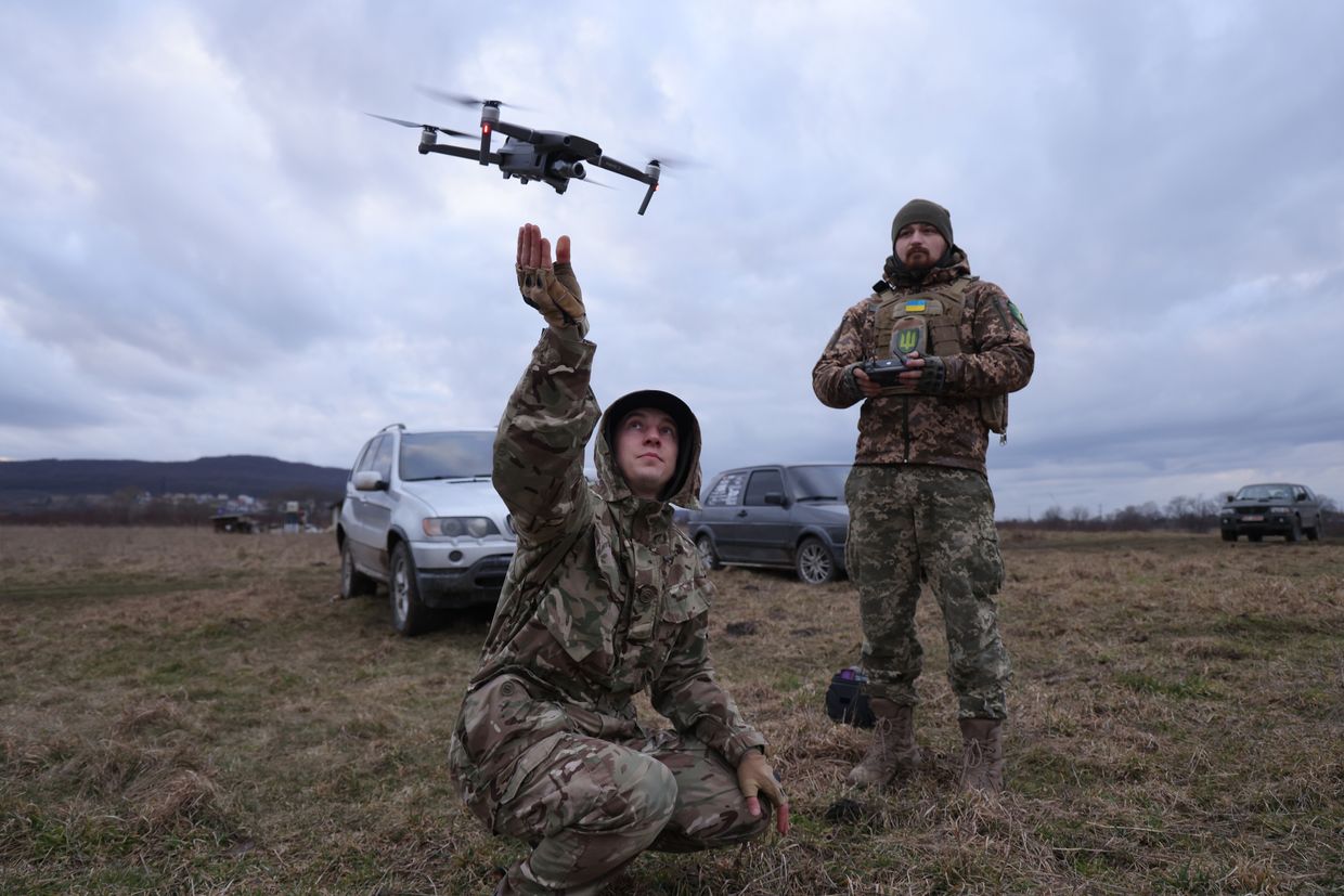 Two men practice flying a drone during a combat training day in  Lviv Oblast, Ukraine, on Feb. 22, 2023.