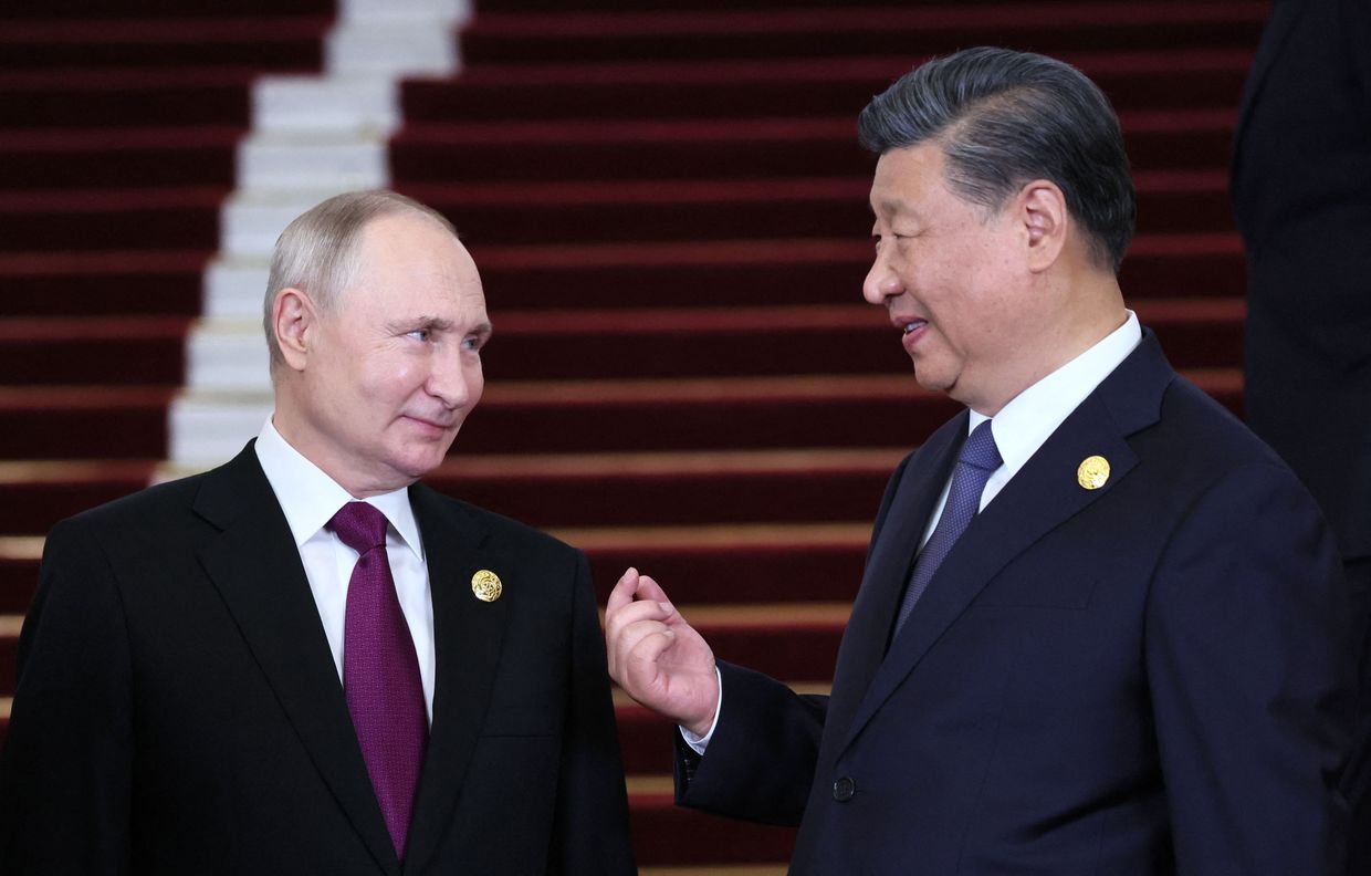 Vladimir Putin and Xi Jinping interact at the Belt and Road Forum in Beijing on Oct. 17, 2023.