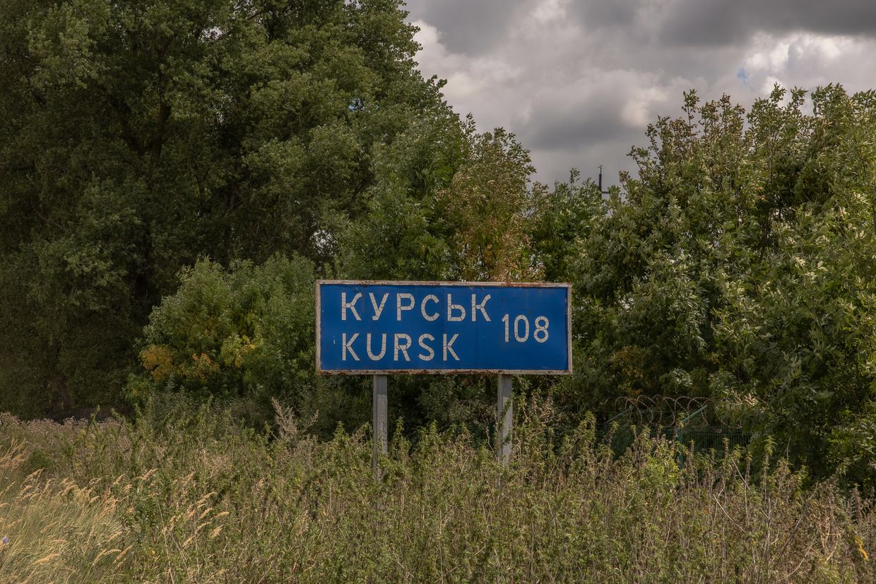 A road sign showing the distance to the Russian town of Kursk 