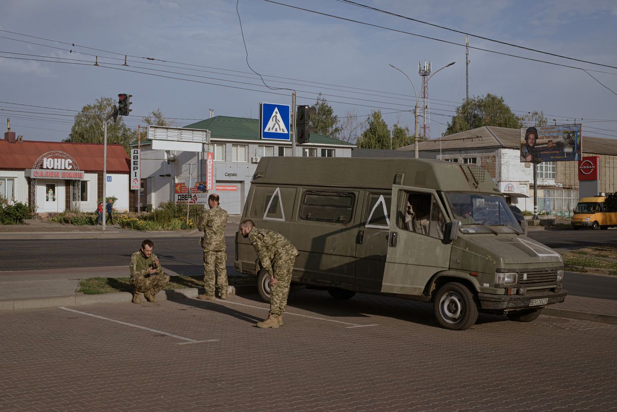  Soldiers stand near a military vehicle in Khotin, Ukraine, 30 km from the Russian border, a hub amid Ukraine's Kursk advance on Sep. 13, 2024.