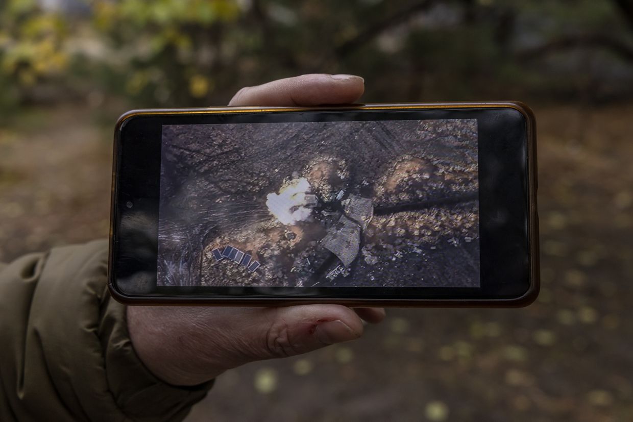 Soldier shows a video of his unit's drone destroying Russian equipment, as seen in Sumy Oblast, Ukraine, on Nov. 6, 2024