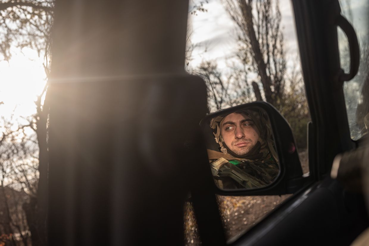  A Ukrainian soldier is reflected in a car mirror en route to a fighting position near Toretsk, Donetsk Oblast, Ukraine, on Nov. 17, 2024.