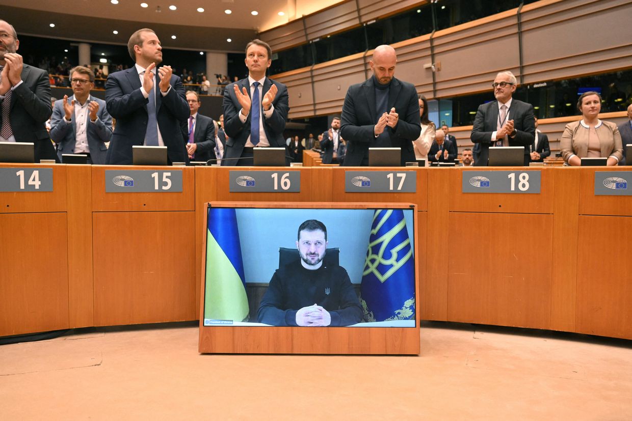  EU Parliament members applaud during a standing ovation before Ukraine's President Volodymyr Zelensky's videoconference in Brussels on Nov. 19, 2024.