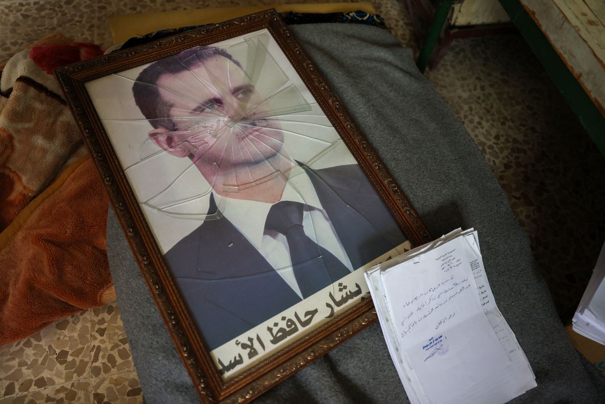 A broken portrait of Syrian President Bashar al-Assad is seen in a regime facility near Hama, Syria, captured by rebels on Dec. 7, 2024.