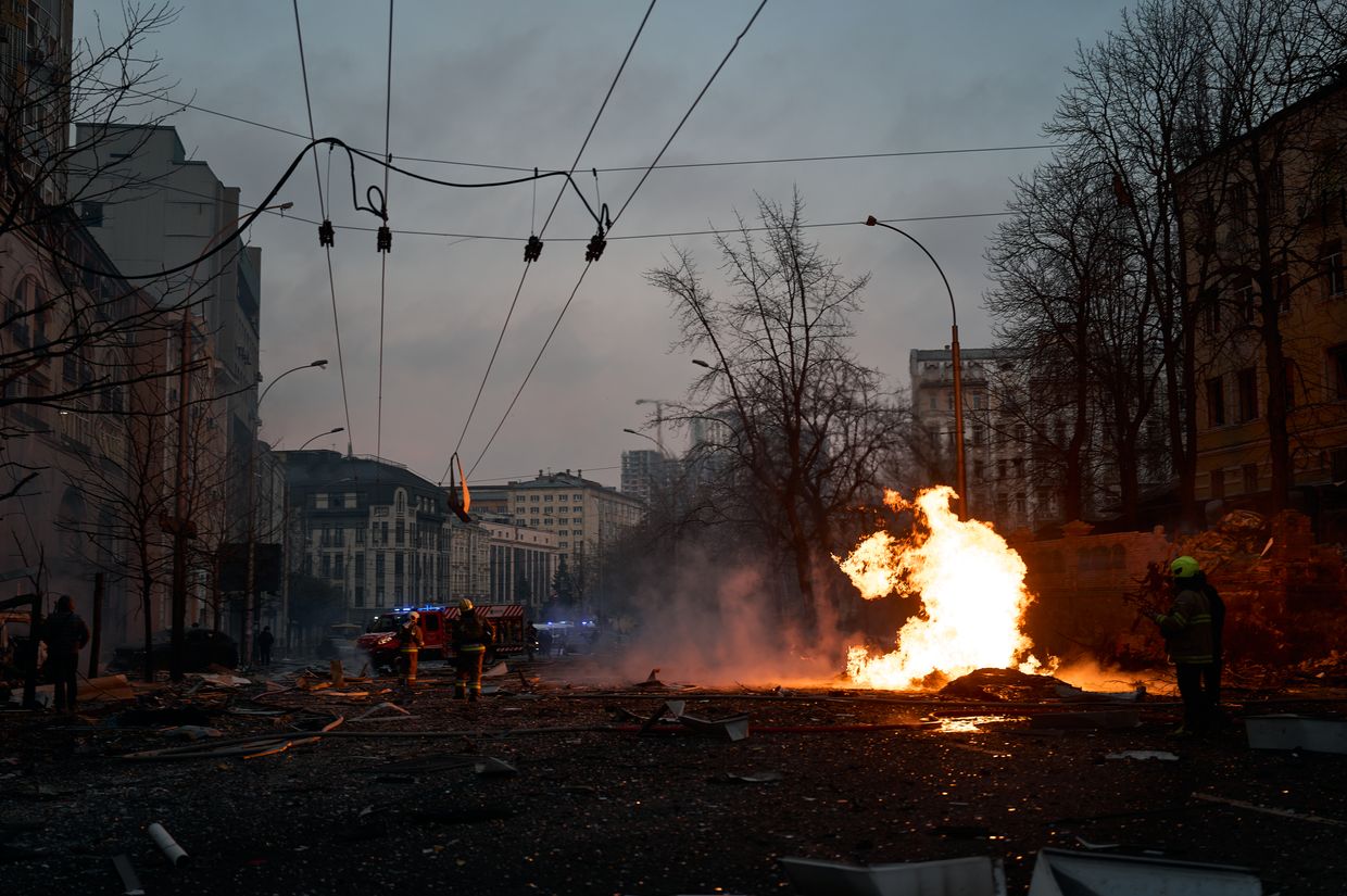 Ukrainian rescue services clear debris after a Russian ballistic missile strike in central Kyiv, Ukraine, on Dec. 20, 2024. 