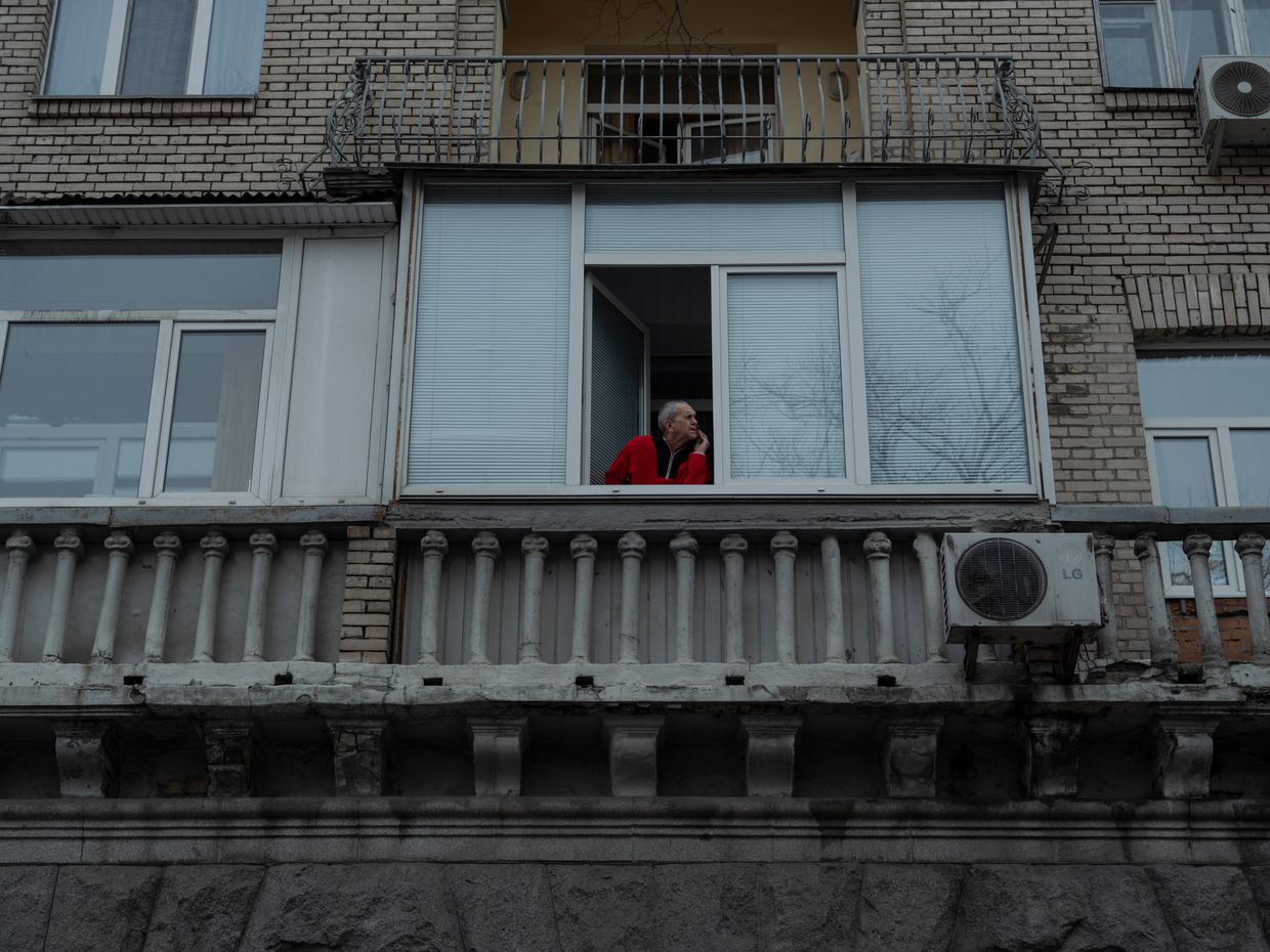 A Kyiv resident looks in the direction of an explosion in Kyiv, Ukraine, on Dec. 20, 2024.