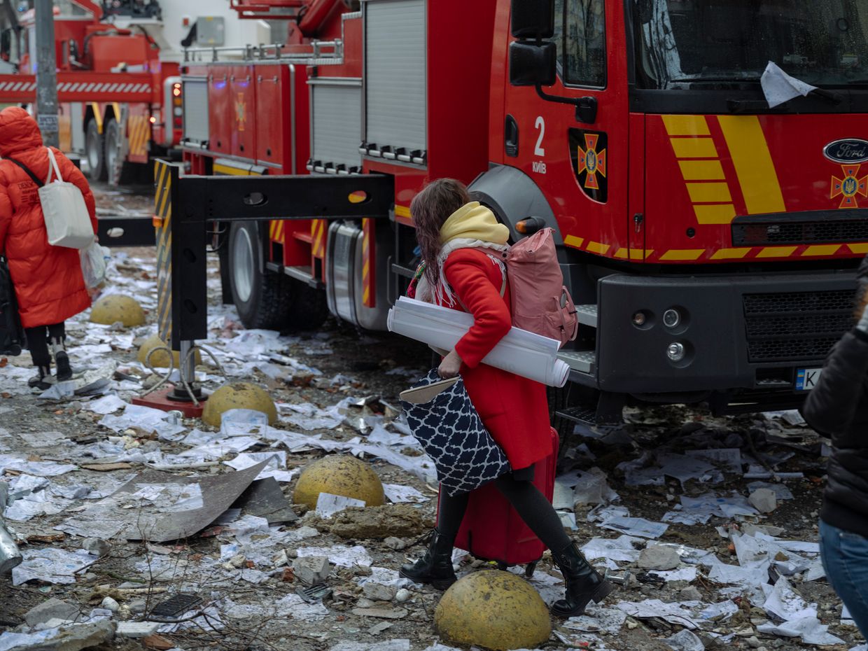 Hotel guests left the heavily damaged Holiday Inn after a missile strike in Kyiv, Ukraine, on Dec. 20, 2024. 