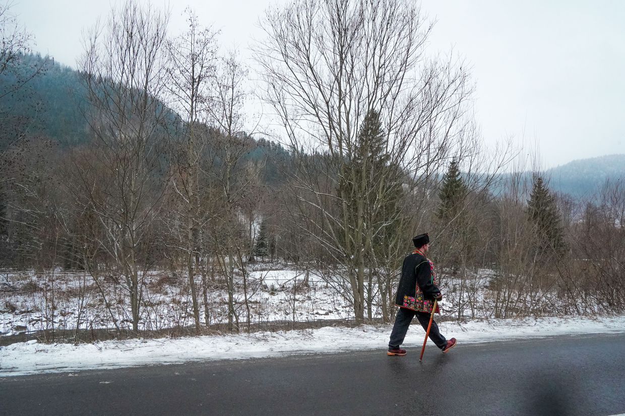 Caroller walks down the street in Kryvorivnya village in Ivano-Frankivsk Oblast, Ukraine on Dec. 25, 2024. 