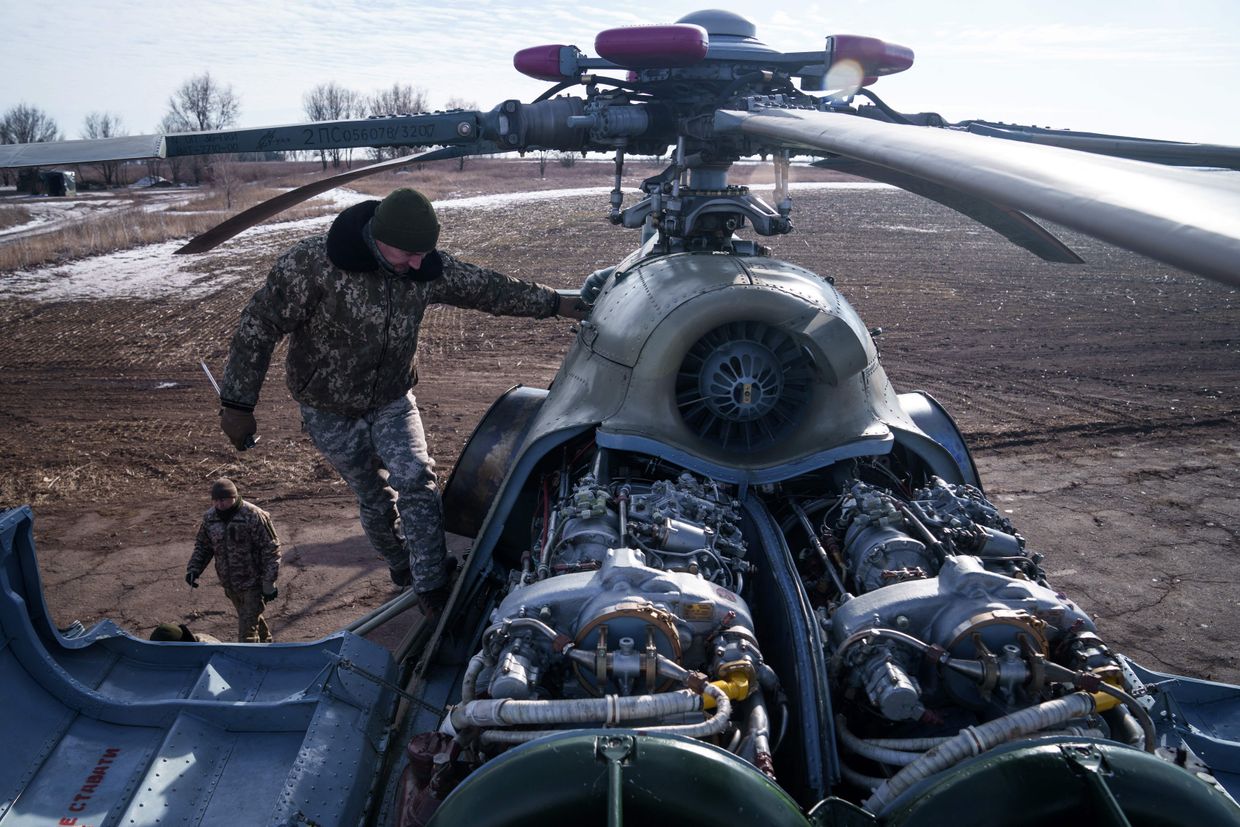 A crew member inspects the engines of a Mi-8 helicopter before a sortie in eastern Ukraine on Feb. 9, 2023