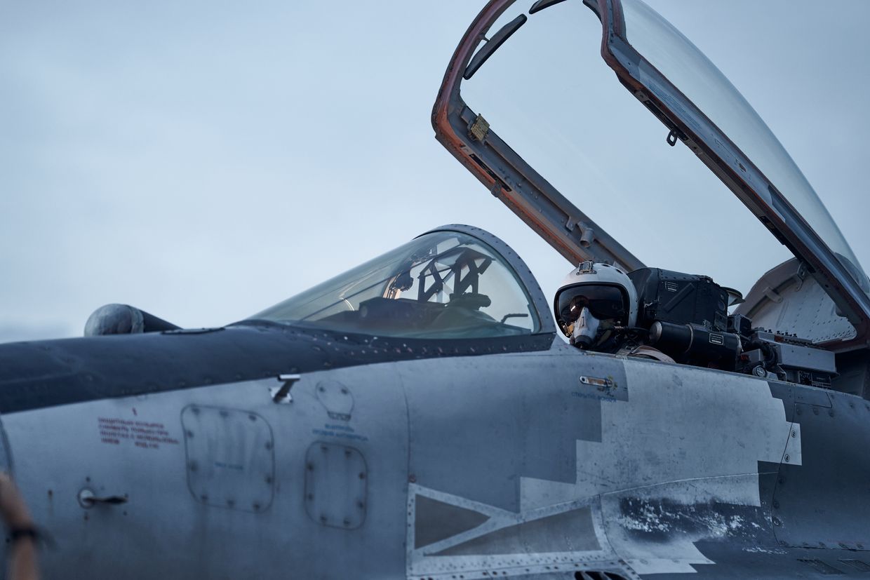 A Ukrainian Tactical Aviation pilot poses in the cockpit of his MIG-29 fighter jet at sunset in eastern Ukraine on Aug. 1, 2023. 