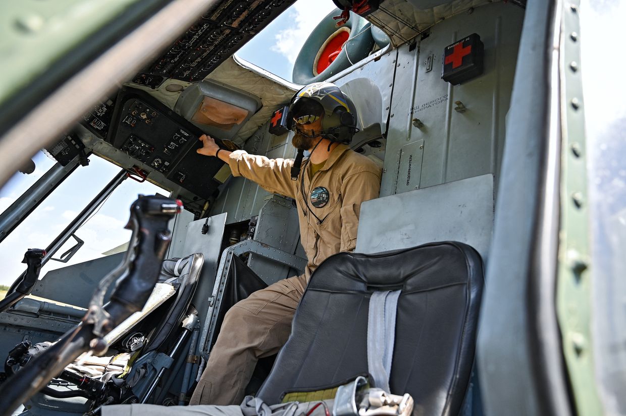 A flight engineer checks a Mi-8MSB-V helicopter's systems at an undisclosed location in Ukraine on July 11, 2024.