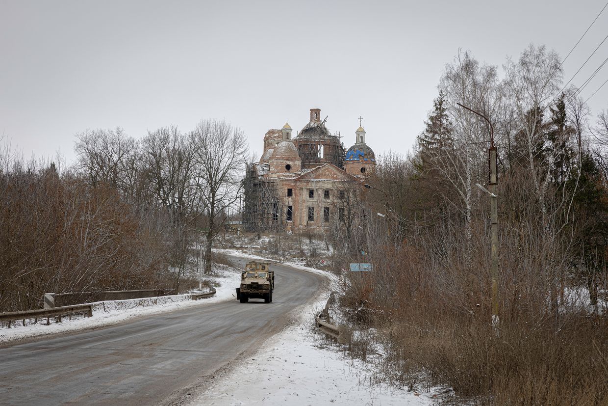 A Ukrainian armored vehicle heads to the Russian border from Sumy, passing a destroyed church in Yunakivka, Sumy Oblast, Dec. 8, 2024.