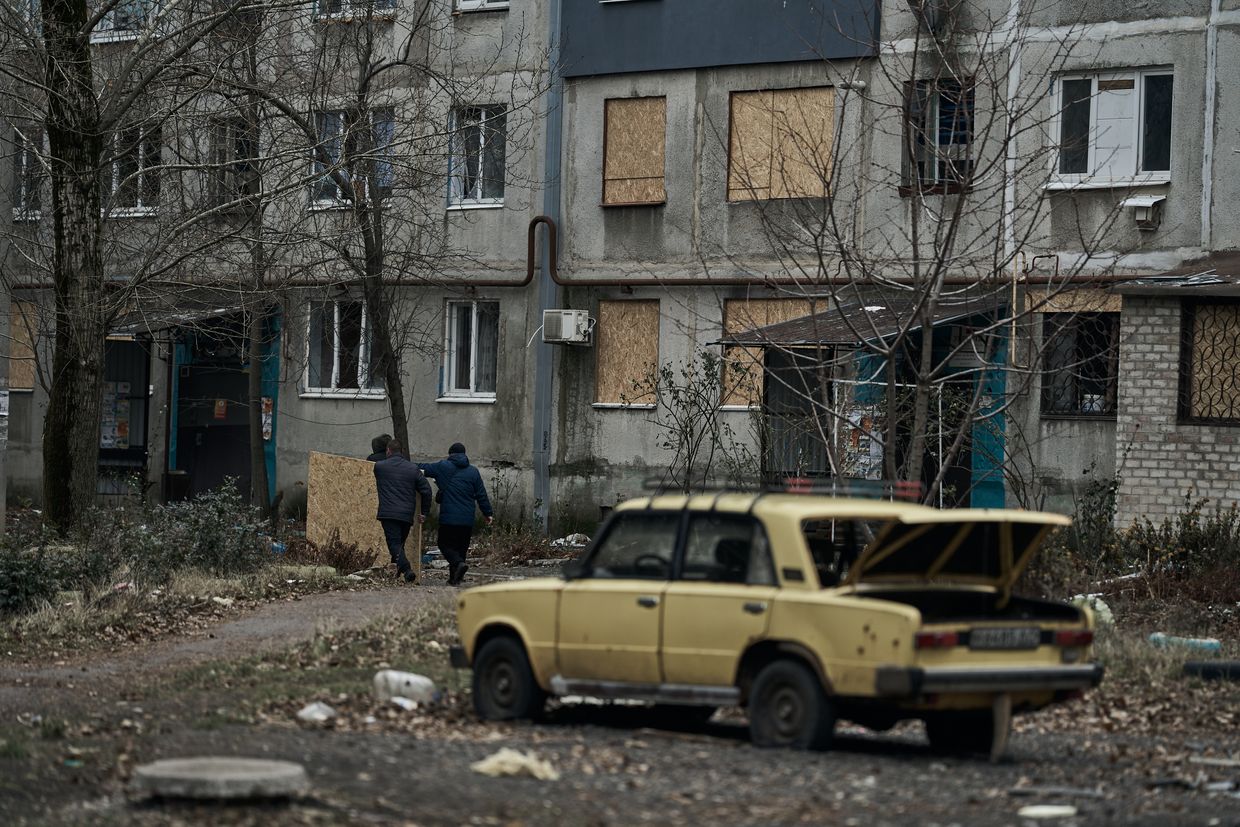  Local workers replace broken windows with chipboard after shelling from MLRS in Pokrovsk, Donetsk Oblast, Ukraine, Dec. 27, 2024.