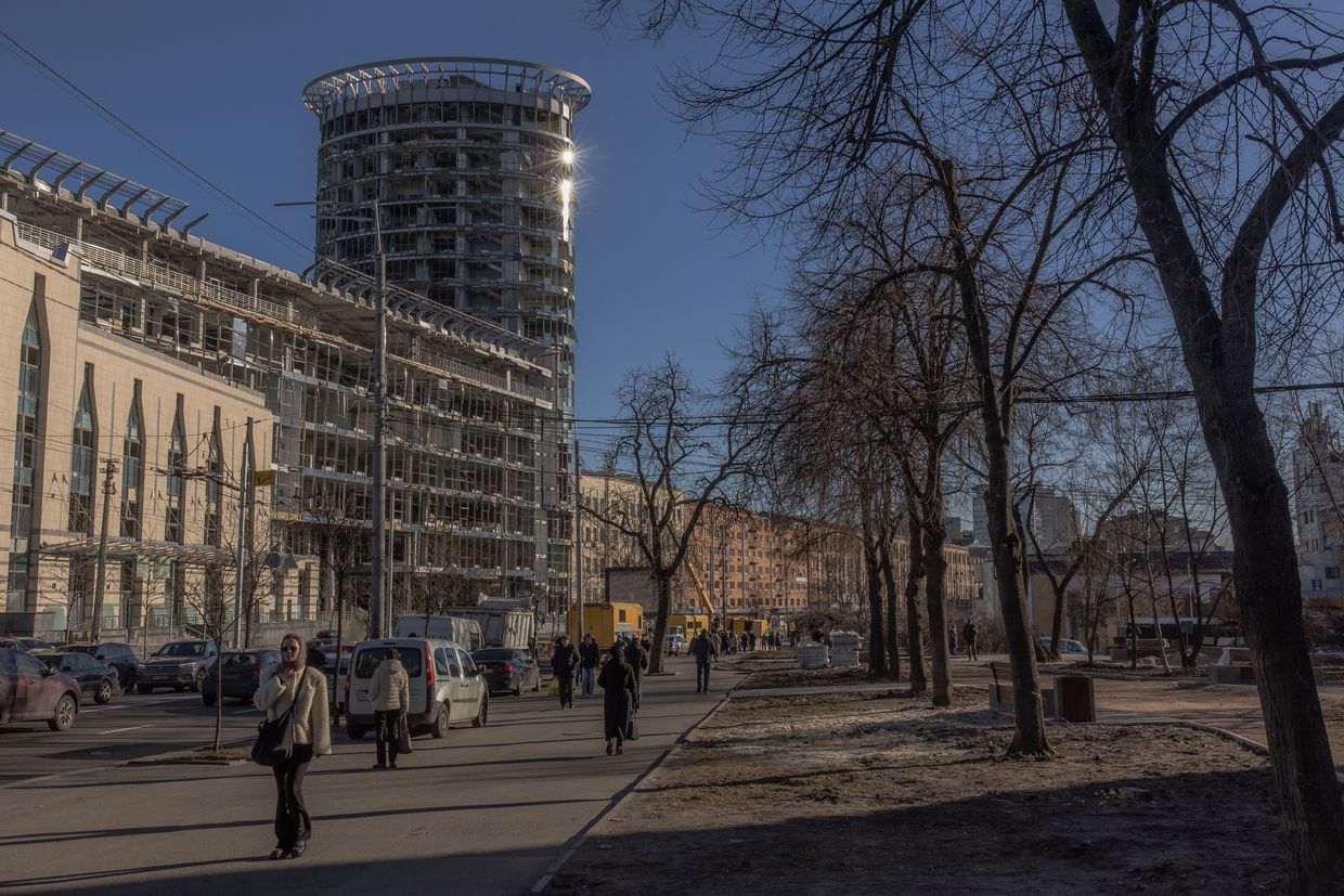 People walk past damaged buildings after a Russian missile attack in Kyiv, Ukraine, on Jan. 19, 2025.