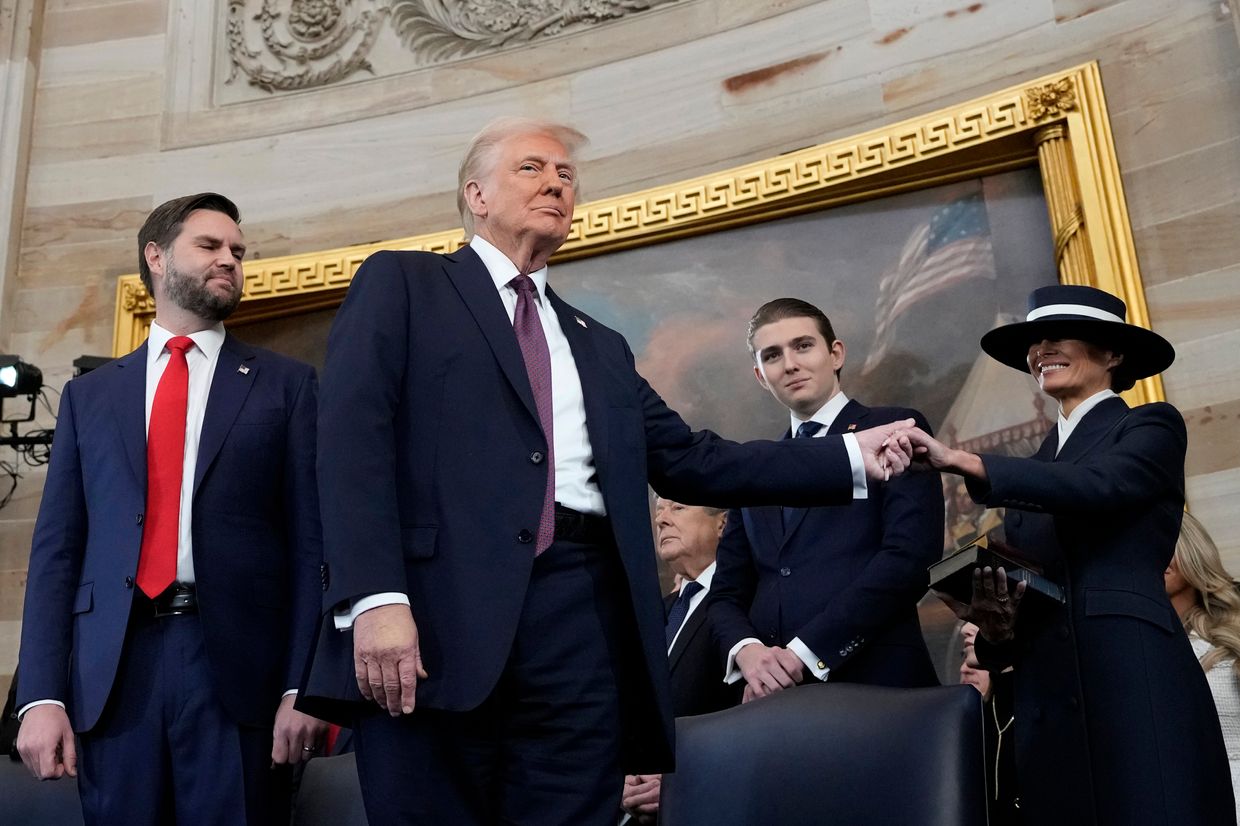 Trump holds Melania's hand as Barron Trump and VP J.D. Vance look on after his oath at the U.S. Capitol, Jan. 20, 2025.