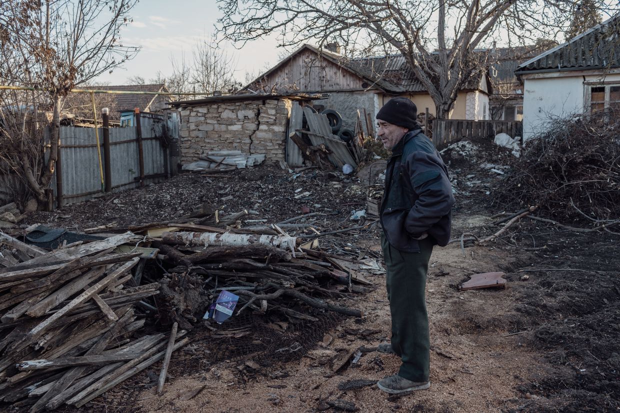 Oleg, with a pile of wood, in Varniţa, Moldova on Jan. 8, 2025.