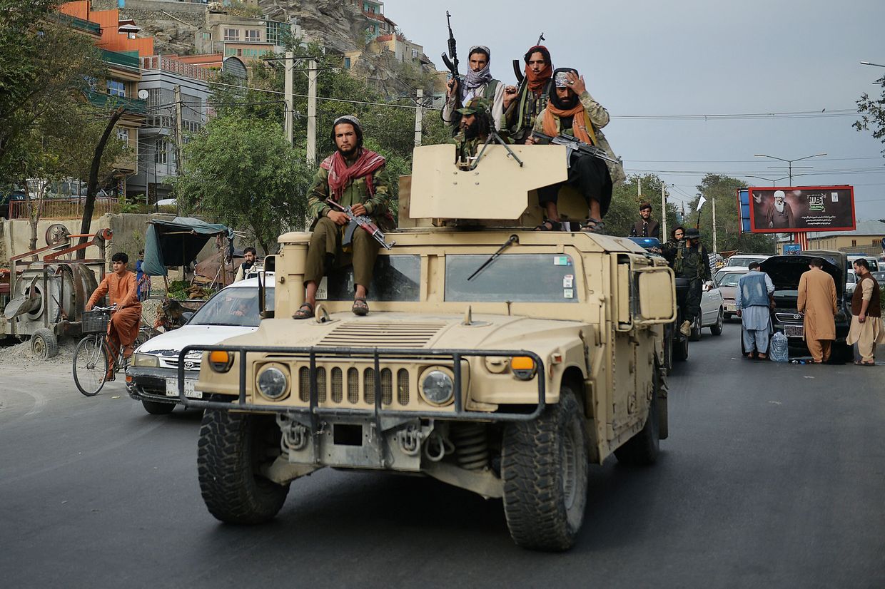 Taliban fighters atop a Humvee take part in a rally in Kabul, Afghanistan, on Aug. 31, 2021, celebrating the U.S. troop withdrawal.