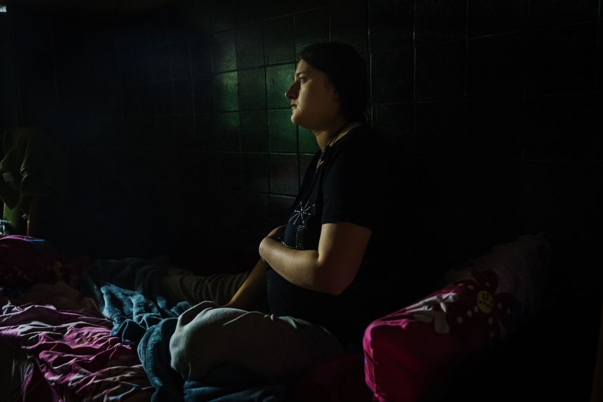 Anna, 19, sits in a dark shelter after a maternity ward moved underground for safety in Kharkiv, Ukraine, on March 25, 2022. 