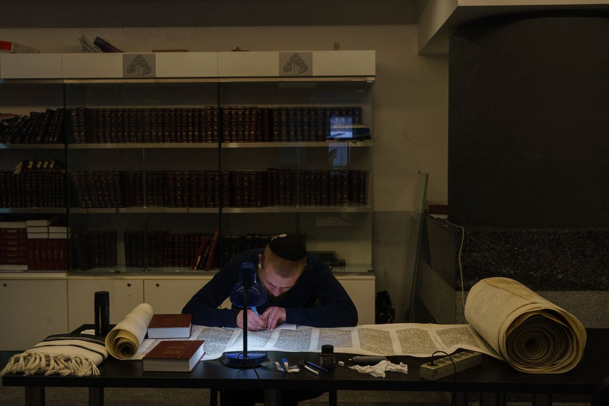 A local Orthodox Jewish man writes the Torah at the Menorah Centre, said to be the world’s largest Jewish community center, in Dnipro, Ukraine, on March 24, 2022.