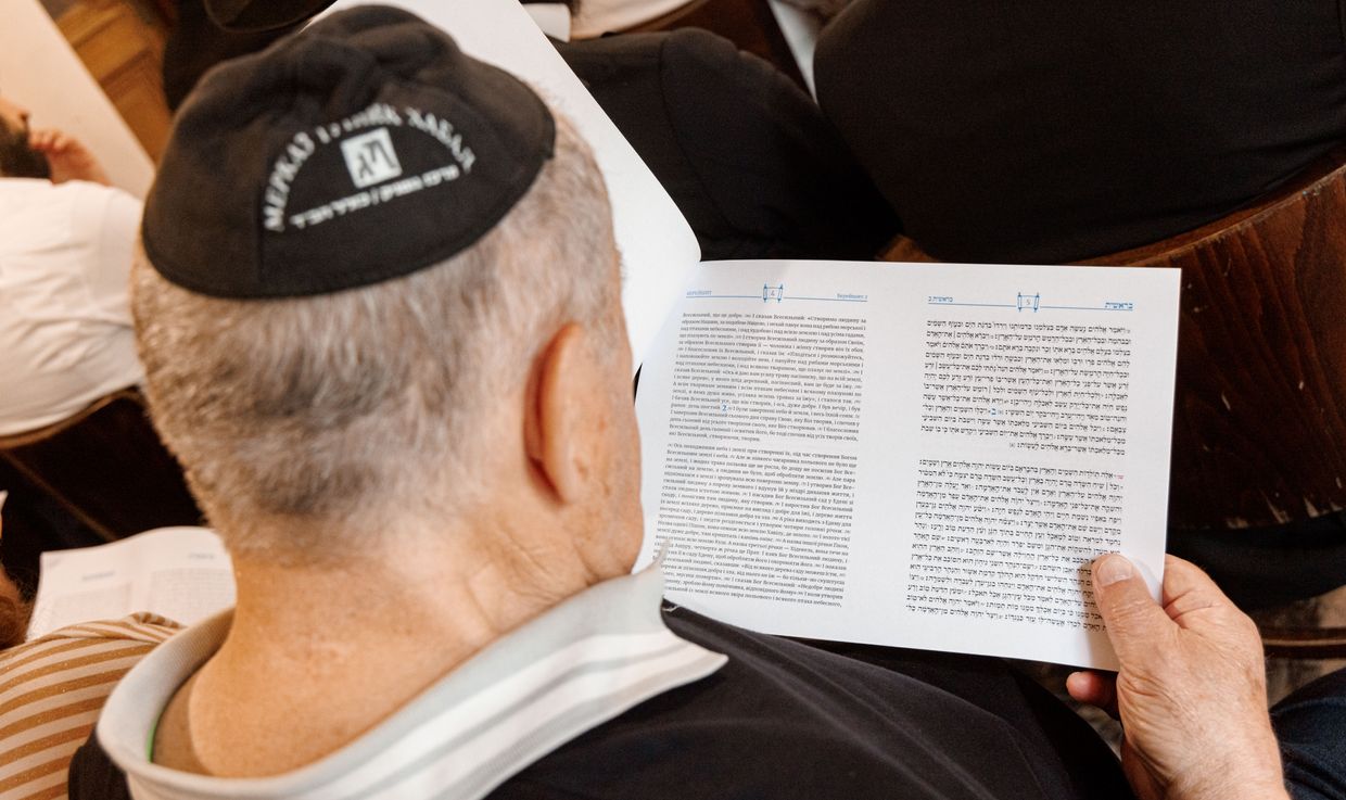 A visitor reads the first pages of the Torah in Ukrainian during a press conference in Hamburg, Germany, on June 27, 2023. 