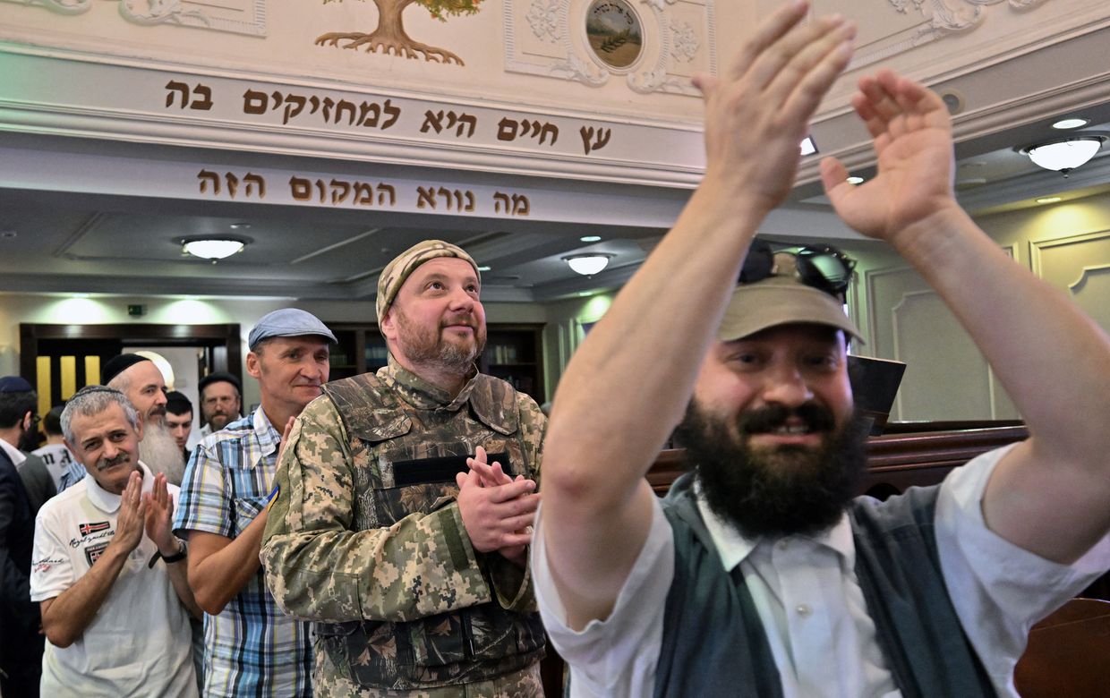 A Jewish Ukrainian serviceman takes part in the inauguration ceremony of a new Sefer Torah in memory of fallen Ukrainian soldiers at a synagogue in Kyiv, Ukraine, on Sept. 22, 2023. 