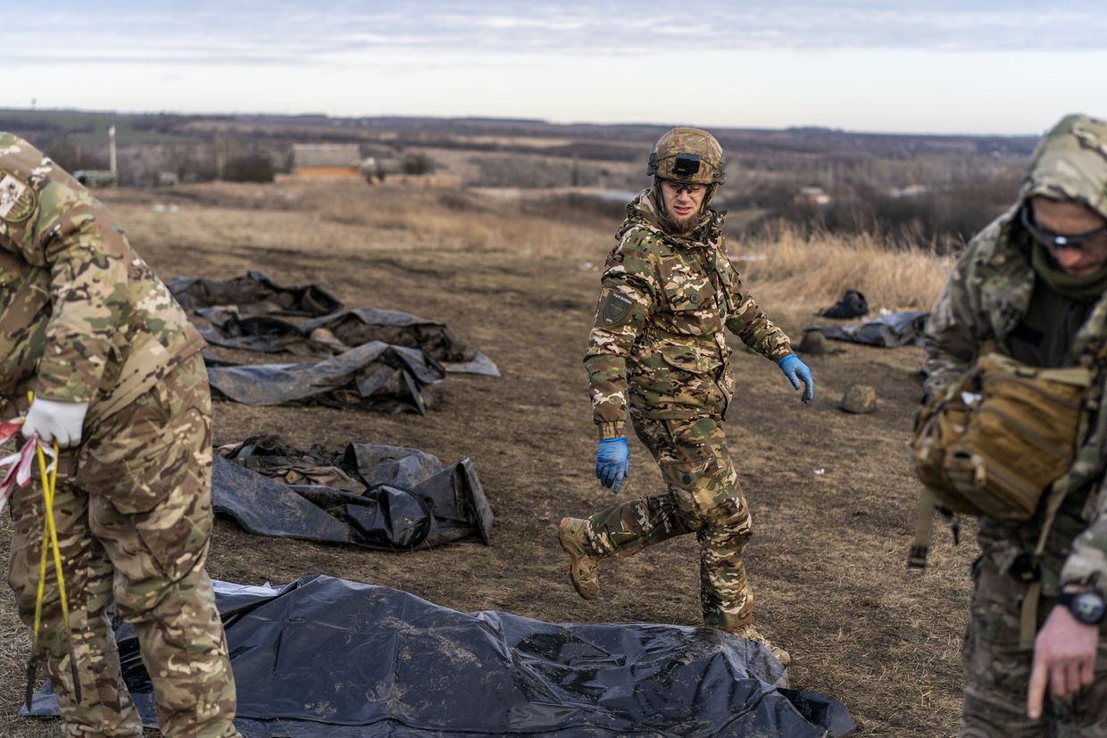 Oleksiy Yukov, head of Black Tulip, leads volunteers as they examine personal belongings of two Russian soldiers