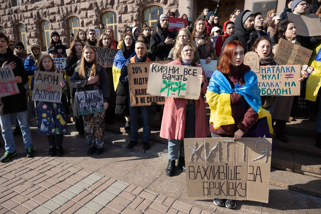 Protesters hold placards during a rally against corruption in Kyiv, Ukraine, on March 2, 2024. 