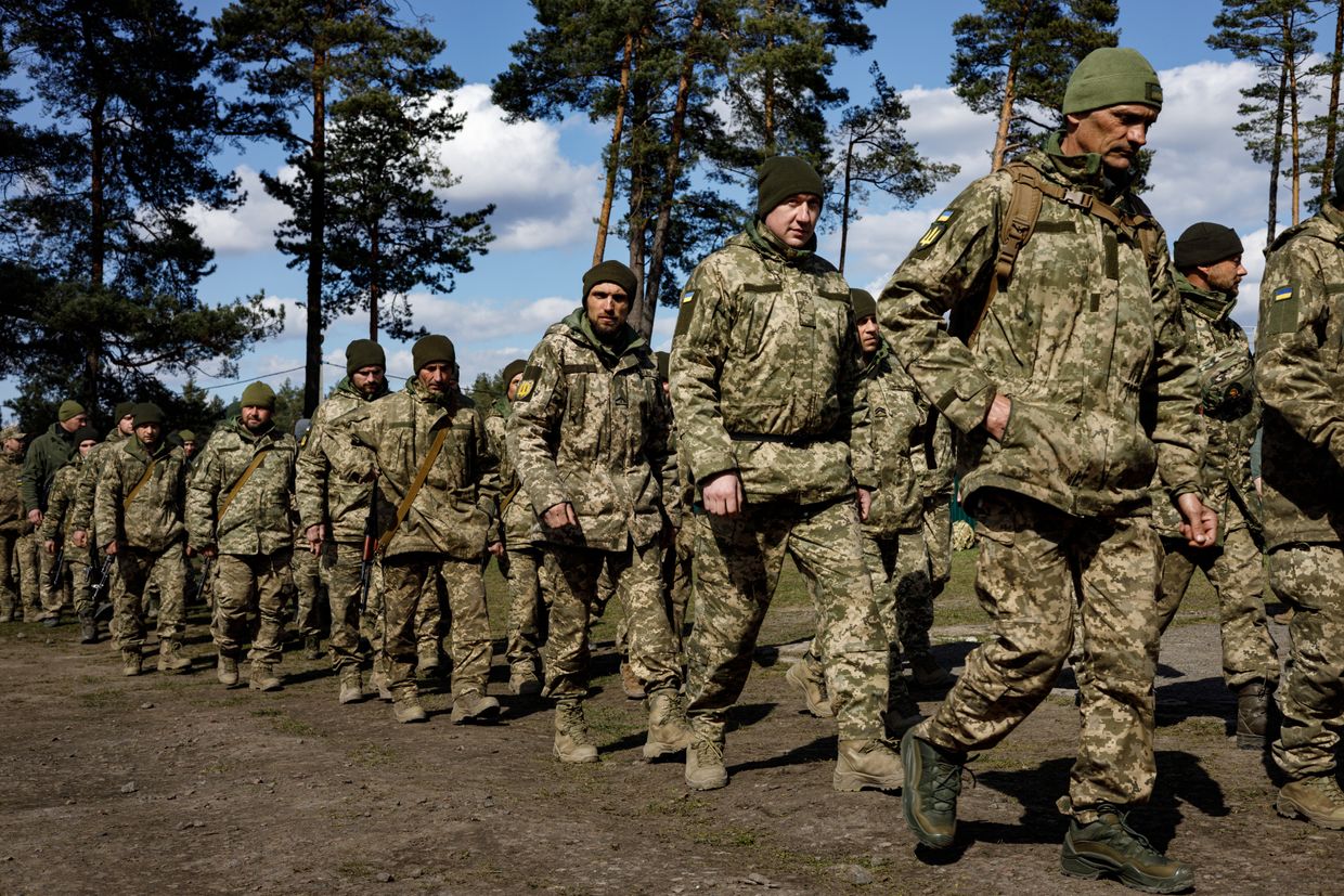 Male volunteers in military uniform at the conscription point after signing a contract with the Ukrainian army in Unspecified, Ukraine, on March 26, 2024.