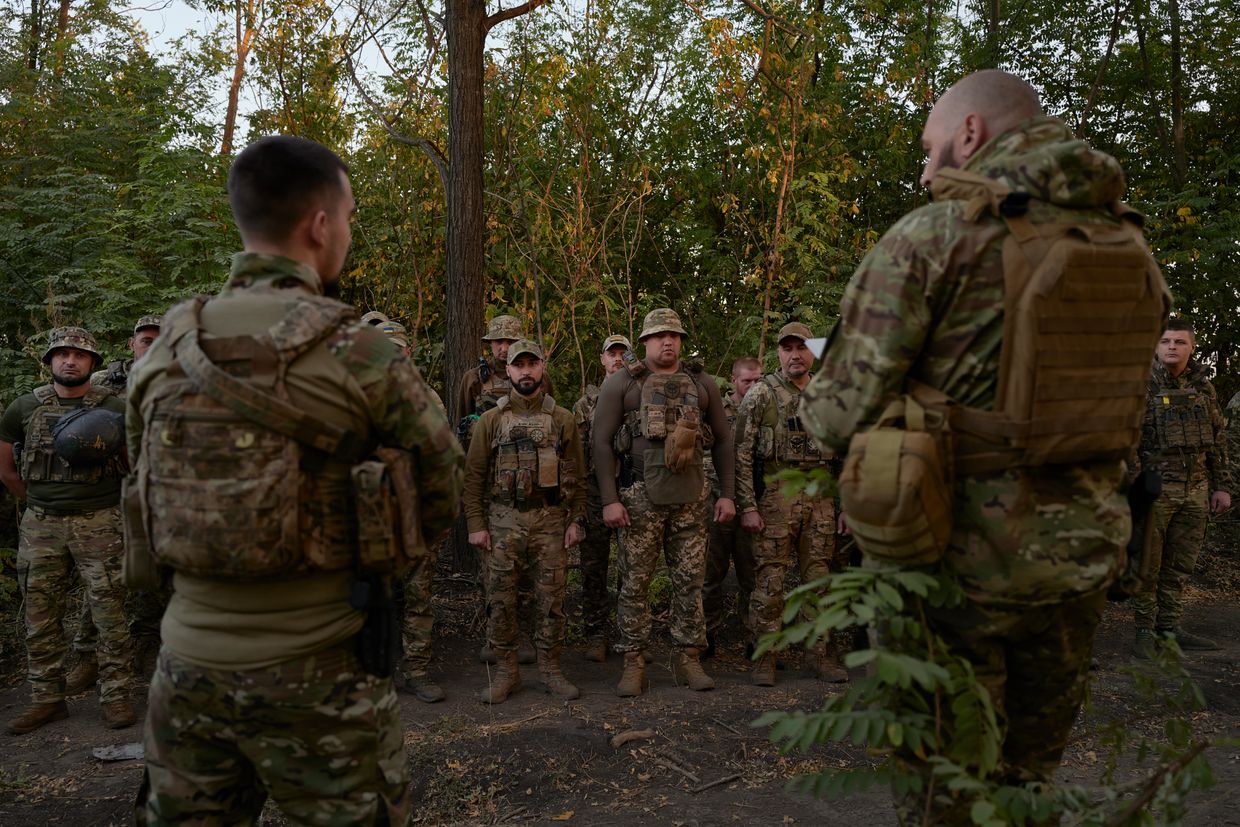 Commander Kucher (L) of the 21st Battalion, Separate Presidential Brigade, awards medals to soldiers for their courage and service on Ukraine Defender Day in Pokrovsk, Ukraine, on Oct. 1, 2024.